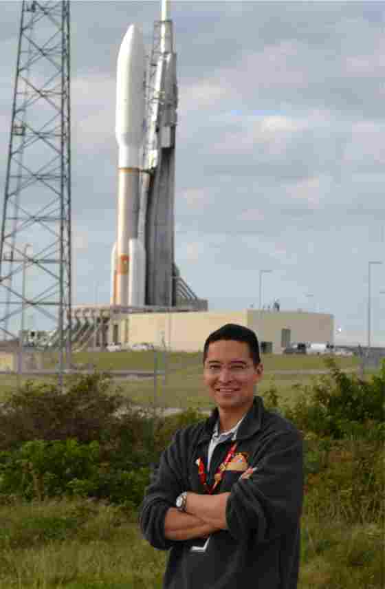 Steven Lee of NASA's Jet Propulsion Lab standing in front of the MSL Atlas V rocket. 