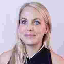 Young woman with blonde hair and blue eyes with black shirt. Head shot