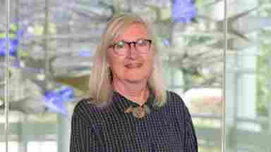 Cindy Samuelson is wearing a black blouse with blue lights, landscape- hero. Assistant Director of Sponsored Research