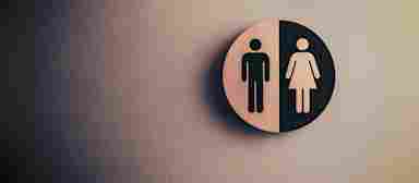 Men and women's restroom signs hang on the wall.