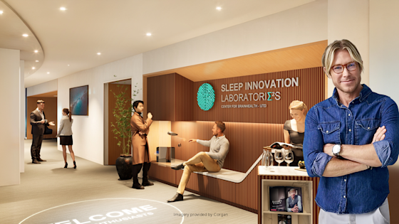 Neuroscientist and sleep expert Matt Walker, PhD, stands in a bright, modern entryway with biophilic design elements, the Sleep Innovation Laboratories at Center for BrainHealth, part of UT Dallas.