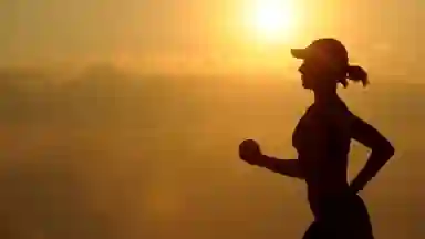 Woman with white sun visor enjoying an athletic run. 
