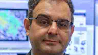 Dr. David Lary in a suit in front of computers, portrait. Professor of Physics in the Hanson Center for Space Sciences; Founding Director of MINTS (Multi-Use Multi-scale Integrated Interactive Intelligent Sensing and Simulation in Service of Society); Center for Brain Health Investigator