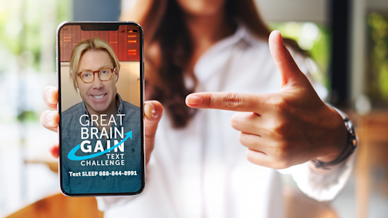 Woman holding mobile phone with welcome screen for the Great Brain Gain sleep text challenge from Center for Brainhealth