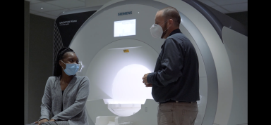 Jason posing as researcher with participant (Angelica) in MRI room