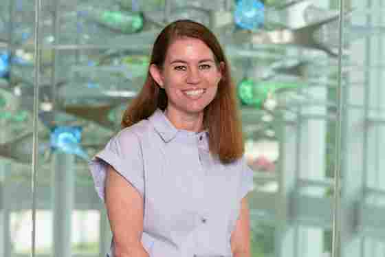 Jennifer Zientz in a light blue blouse with green and blue lights, horizontal. Close-up. Head of Clinical Services; Deputy Director, Performance- hero