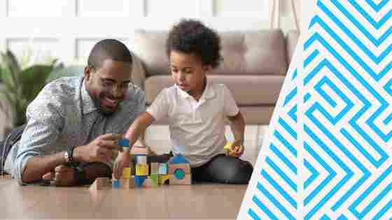 Caring young single father help cute kid son play on warm floor together, happy dad and little child boy having fun building constructor tower from colorful wooden blocks. IStock# 1158481694.