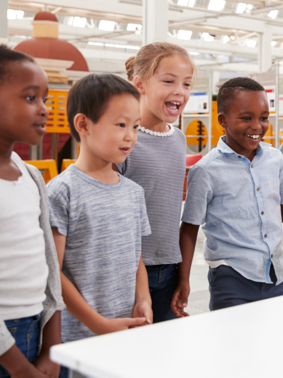 Children smile while learning at a Family Fun Fair.