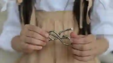 Little girl holding a metal knot puzzle