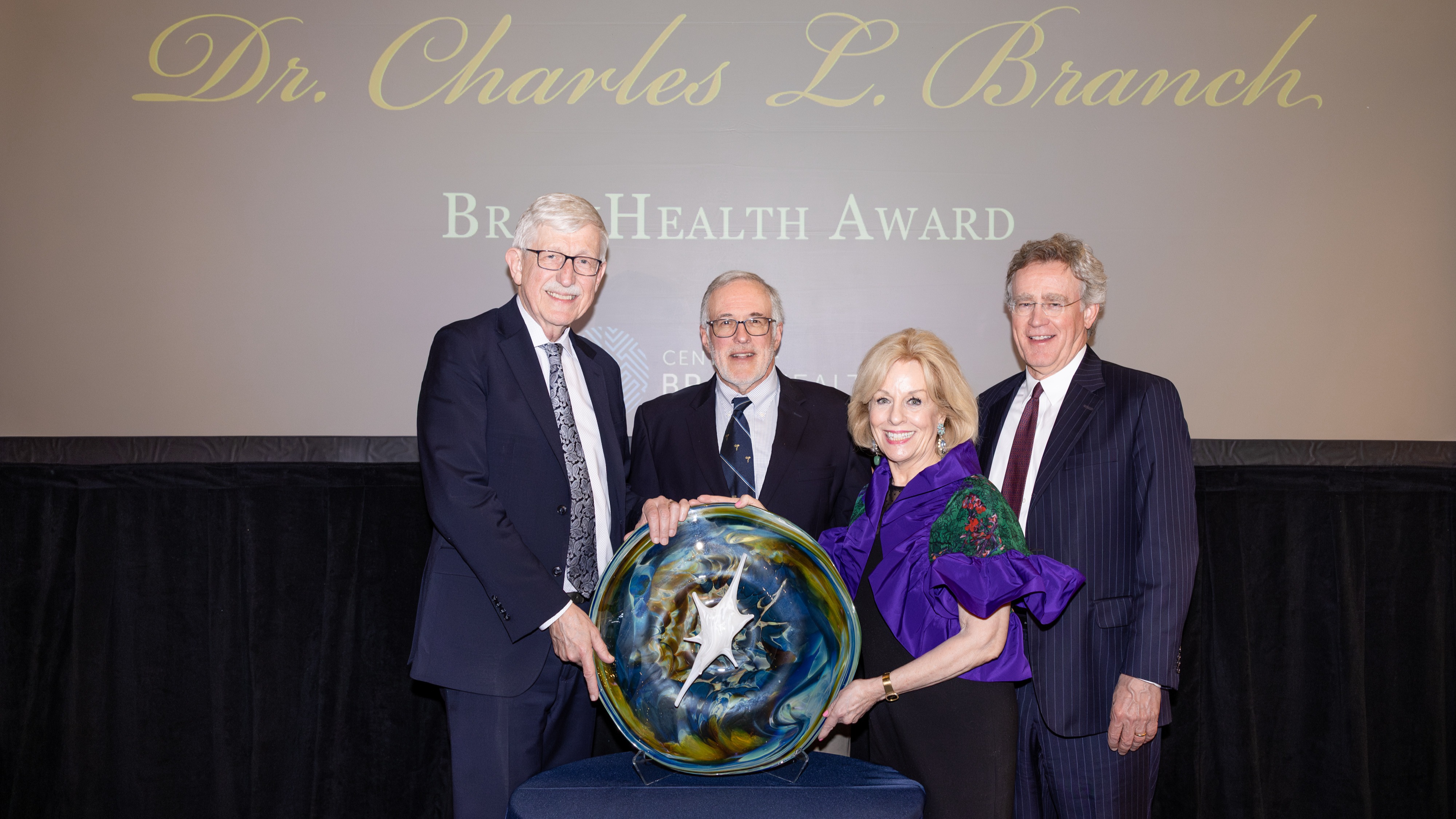 Sandi Chapman, PhD, alongside world‑renowned physician‑scientist Dr. Francis Collins, who led the international Human Genome Project and later the NIH, and the sons of Dr. Charles L. Branch, at the 2026 Branch BrainHealth Award, honoring Dr. Collins' contributions to neuroscience. 