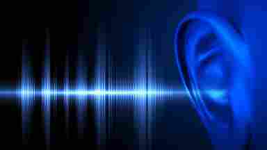 A blue sound wave against a black background; there is a dark blue rendition of an ear receiving the sound wave.