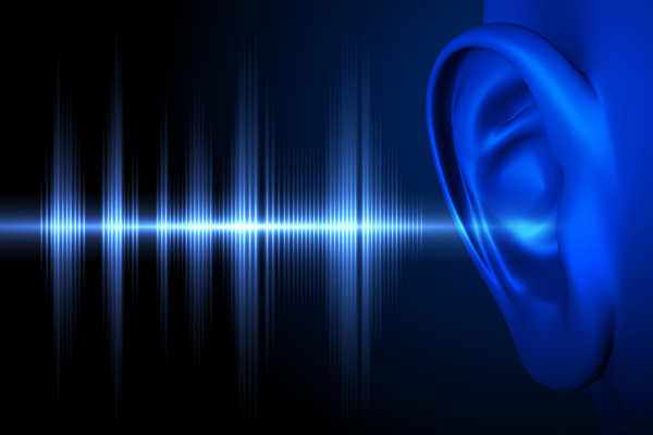 Blue sound wave with a black background. Listening, Hearing. iStock-497748804