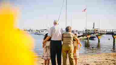Grandparents with Grandchildren standing by the shore
