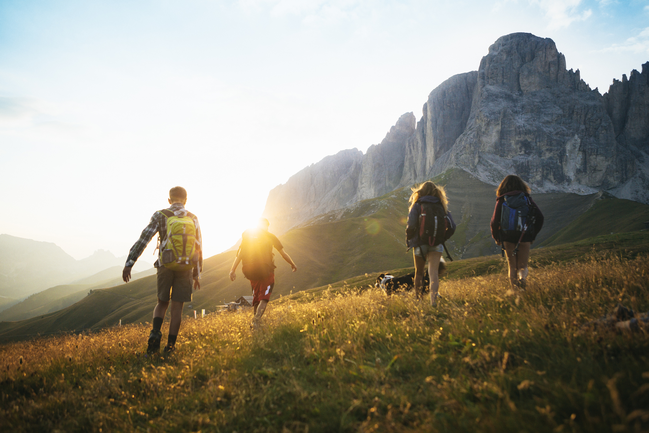 Young adults hike to an exotic mountain range.