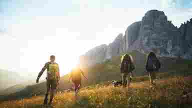 Young adults hike to an exotic mountain range.