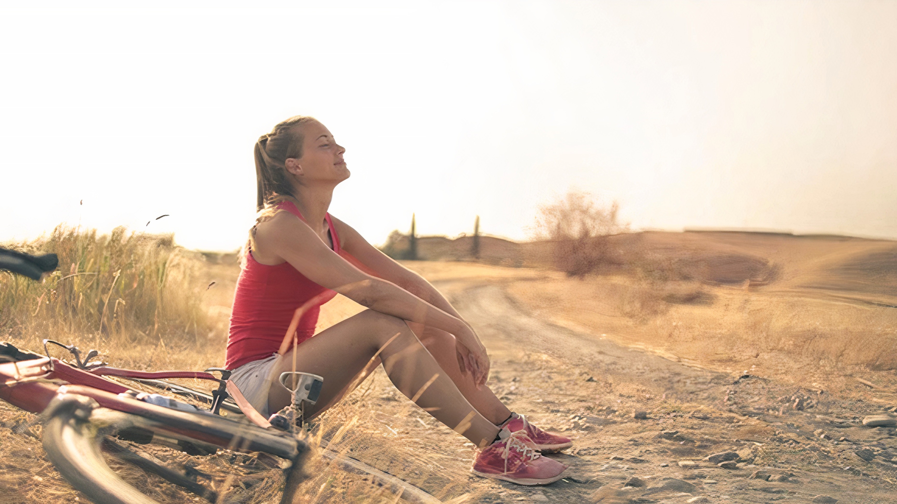 A girl sitting with her bike