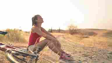 A girl sitting with her bike