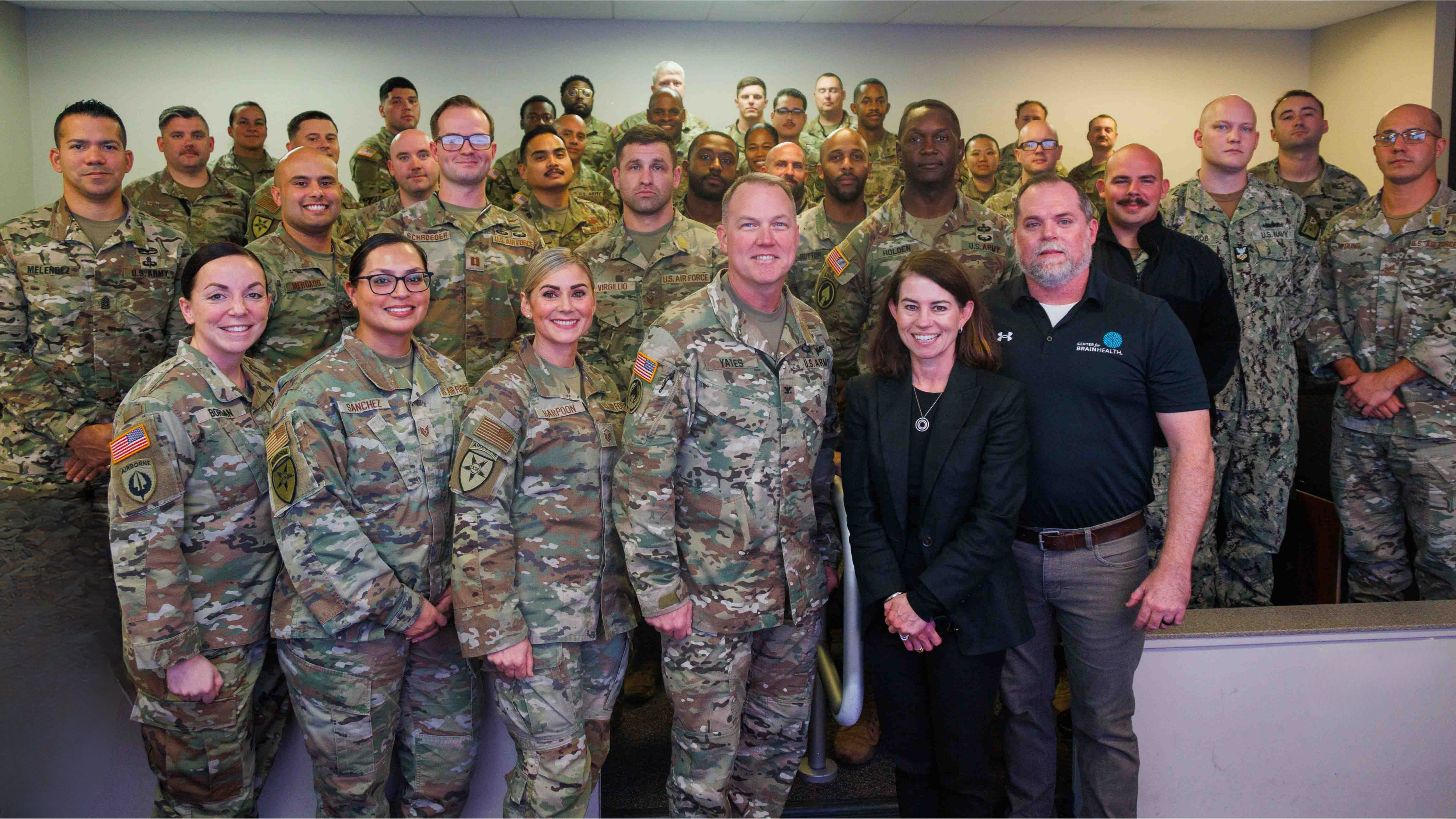 Center for BrainHealth's Jennifer Zientz and Thad King stand with service members participating in Optimal BrainHealth for Warfighters, following a SMART seminar with the Joint Communications Support Element (JCSE) at , FL. The JCSE is a joint command (Army, Navy, Airforce and Marines).
