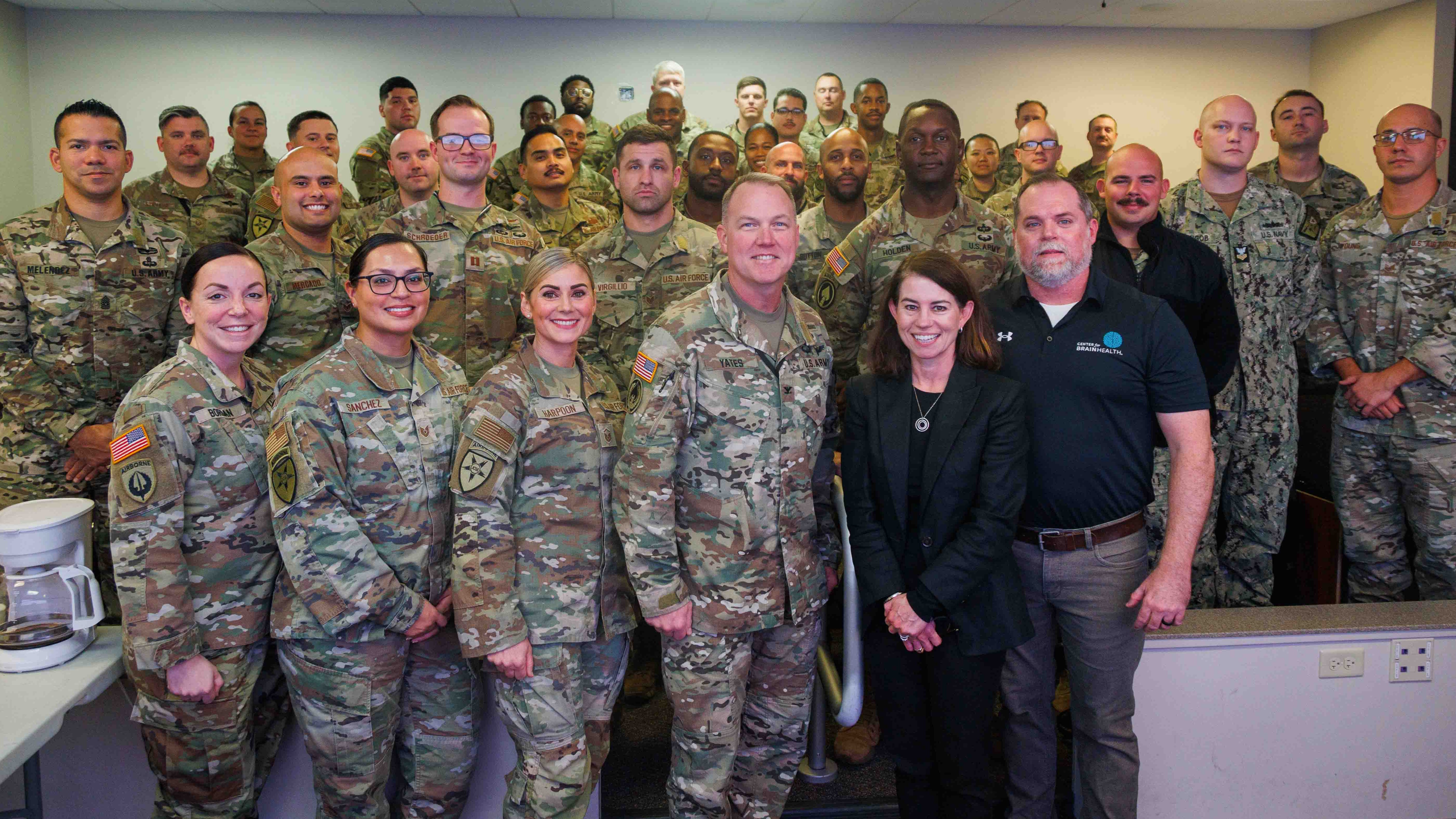 Center for BrainHealth's Jennifer Zientz and Thad King stand with service members participating in Optimal BrainHealth for Warfighters, following a SMART seminar with the Joint Communications Support Element (JCSE) at , FL. The JCSE is a joint command (Army, Navy, Airforce and Marines).