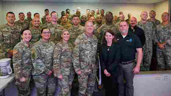 Center for BrainHealth's Jennifer Zientz and Thad King stand with service members participating in Optimal BrainHealth for Warfighters, following a SMART seminar with the Joint Communications Support Element (JCSE) at , FL. The JCSE is a joint command (Army, Navy, Airforce and Marines).