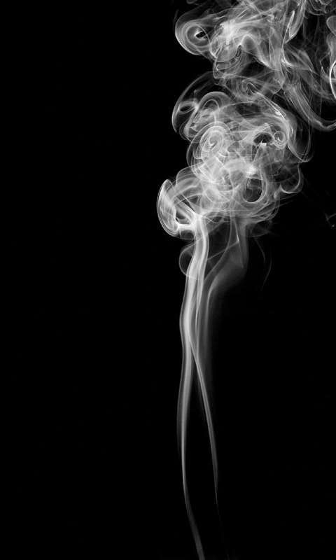 Smoke drifts upwards against a black backdrop.