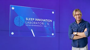 A hallway inside the Sleep Innovation Lab at UT Dallas' Center for BrainHealth, featuring modern lighting and clean architectural lines that create a calm and inviting atmosphere, with Matt Walker, PhD.