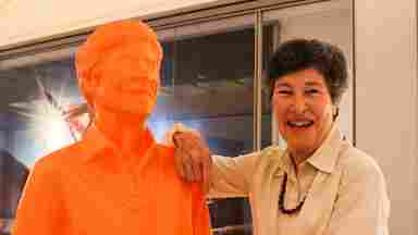 Lyda Hill with an orange statue of herself.