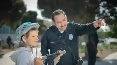 A police officer directing a young biker