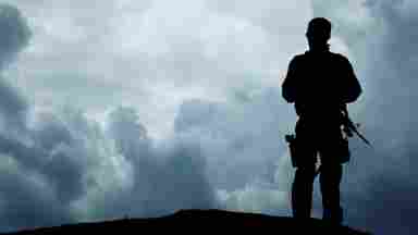 Silhouette of soldier overlooking the horizon