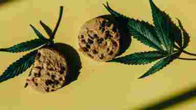 Cookies with a weed leaves in the background.