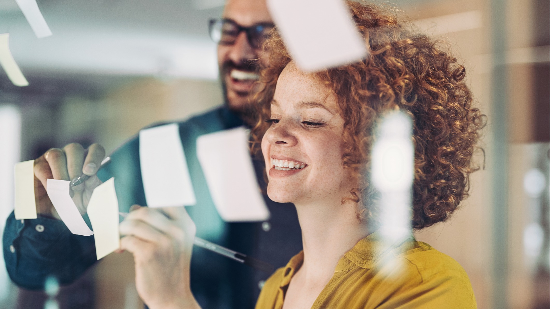 Business partners brainstorm together in a bright office.