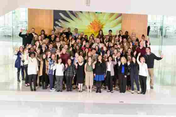 Large group of Center for BrainHealth leadership and staff in Brain Performance Institute (BPI) atrium. 