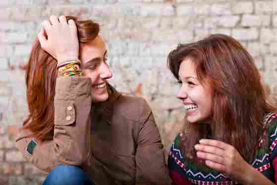 Two young happy girls smiling and laughing together.