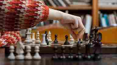 A person making a decisive move in a game of chess.