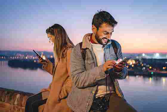 A young couple take Center for BrainHealth's Helpful vs. Harmful Quiz in a picturesque setting.
