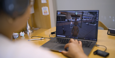 A Charisma participant plays engages with the program on their laptop.