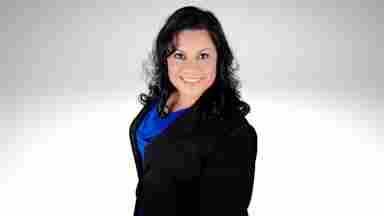 Headshot of Olivia Guerra in a black jacket against a solid white background.