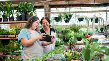 A woman with down syndrome who is a florist working in a garden center.