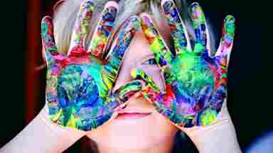 A child with multicolor hand paint