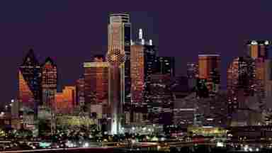 Brown building with lights on during night time