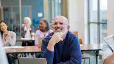 Diverse group of adult students having fun during their adult ed class at a local college.