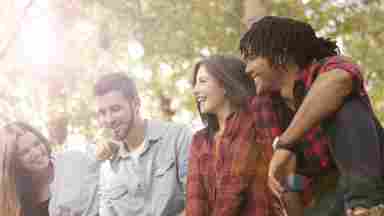 Group of adults smiling and supporting each other.