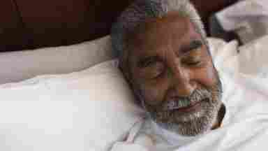 Close-up of a senior man sleeping peacefully.