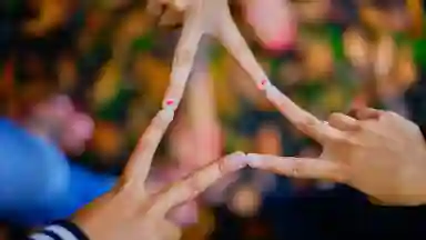 Photography of People Connecting Their Fingers in the Shape of a Triangle.
