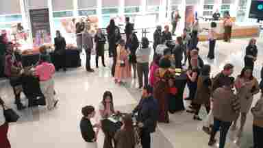 The crowd mingles and enjoys the Art-Infused Happy Hour at BrainHealth Week 2023.
