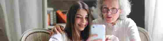 A young teen and grandparent work together happily.