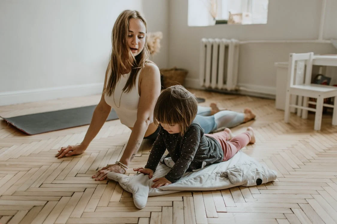 A women and a her child doing yoga