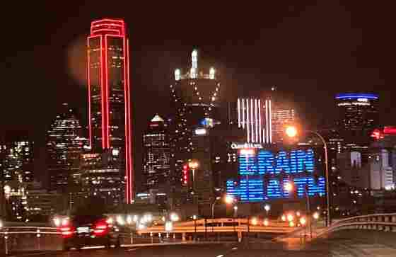 "BrainHealth" displayed in lights on the Omni Hotel in downtown Dallas during BrainHealth Week 2023.