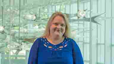 Lori Cook in a blue blouse with green lights, landscape. Director of Clinical Research, BrainHealth Research; Head of Research, The BrainHealth Project; Adjunct Assistant Professor, School of Behavioral and Brain Sciences