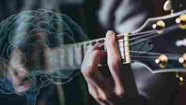 A person playing a guitar with a blue brain overlay. Music.